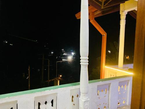 a white column on a balcony at night at VD Rest Gampola in Gampola