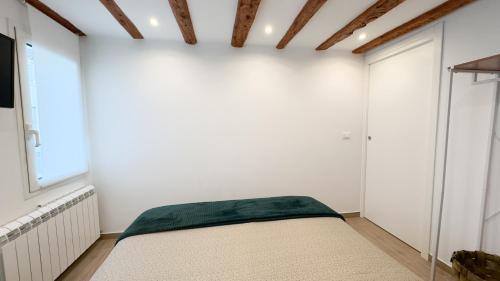 a bedroom with white walls and a bed in it at Maison Studio 2 by Ca-Sa Check in Chioggia