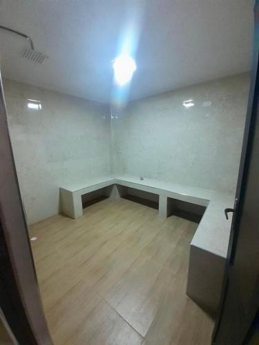 an empty room with a bench and a light at Luxury House in Cochabamba