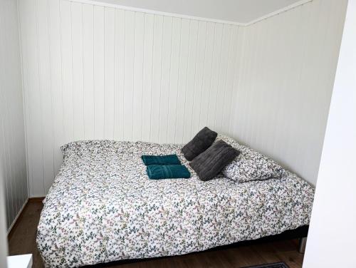 a bed with two pillows on it in a room at Aurora rooms in shared apartment nr2 We are doing privet Northen lights trips, reindeer trip and Fjord sommaroy trip in Tromsø