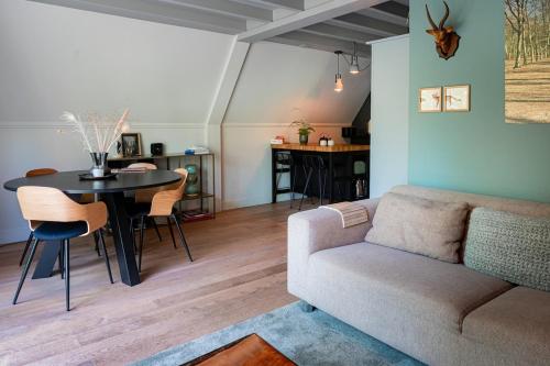 a living room with a couch and a table at Vacation home Magnolia Veluwe in Nunspeet