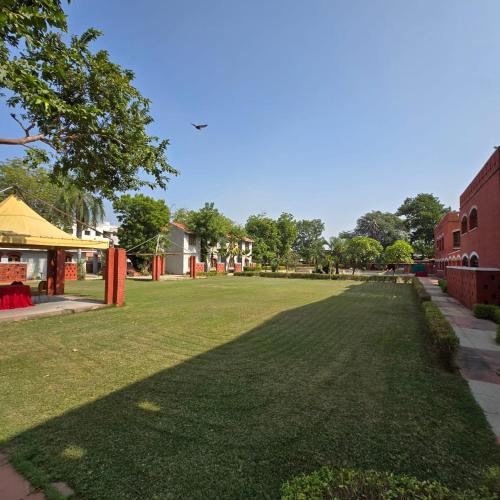 a large grassy field next to a building at The Sky Imperial, Gandhinagar in Gandhinagar