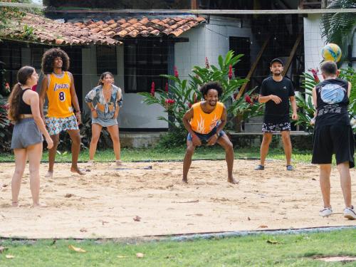 a group of people playing a game of volleyball at Melo Party Hostel Capurgana in Capurganá