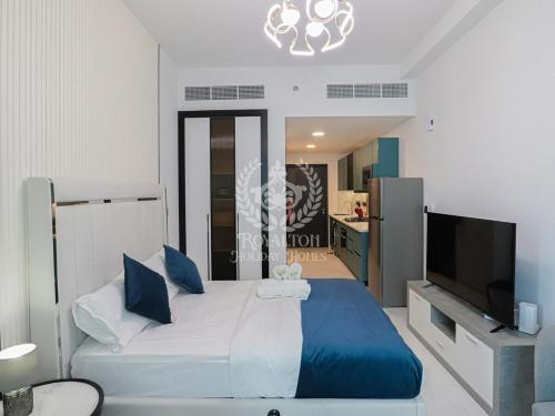 a bedroom with a bed and a flat screen tv at Royalton - Private Pool Luxe Studio in Dubai in Dubai