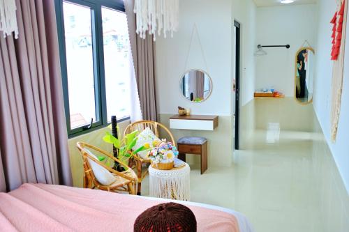 a bedroom with a bed and a table and chairs at Lantana Homestay in Da Lat