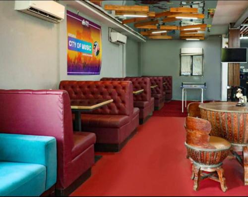 a waiting room with leather couches and a table at City Of Music - Nirvana in Pali