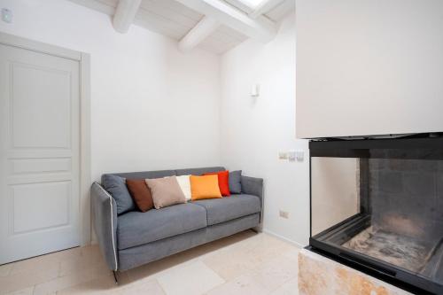 a living room with a couch and a fireplace at Trulli di Titti - Luxury Country House in Castellana Grotte