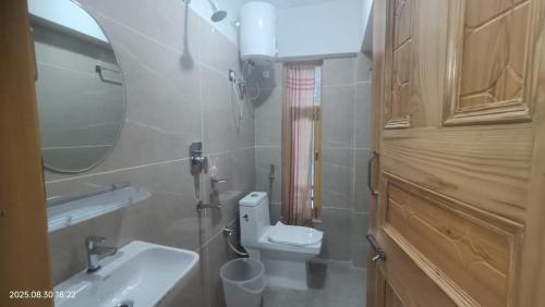 a bathroom with a sink and a toilet and a mirror at Spiti Sidharth Homestay in Kaza