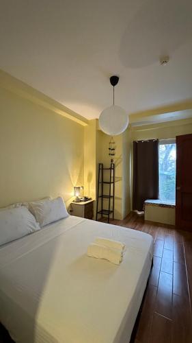 a large white bed in a room with a window at Centrally Located Affordable Apartment with Kitchen in Boracay