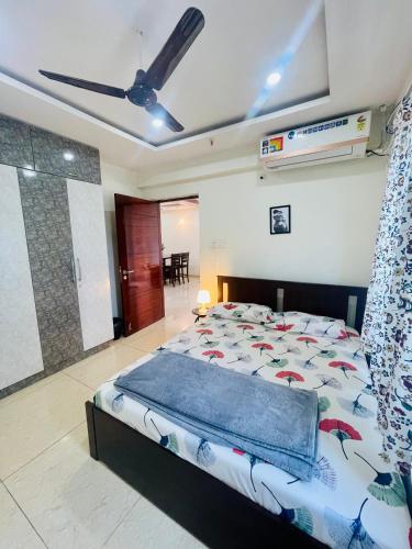a bedroom with a bed and a ceiling fan at SMS properties in Gundipet