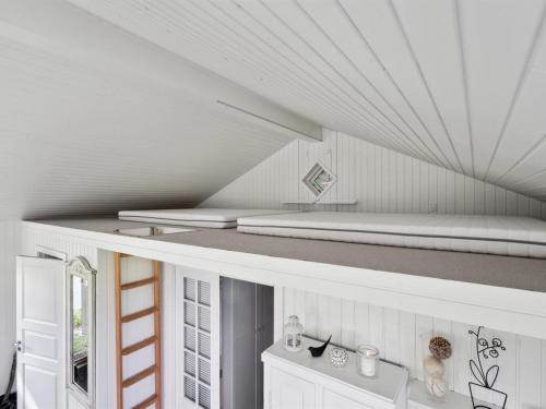 a white room with a bed on the ceiling at Holiday Home Ginne - 100m to the inlet by Interhome in Løgstrup