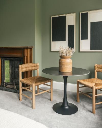 a table and chairs in a room with a fireplace at Old Abbey House in Abingdon