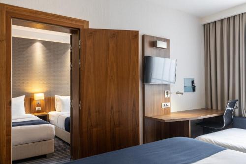 Ένα ή περισσότερα κρεβάτια σε δωμάτιο στο Nobel Palace Hotel