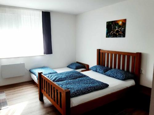 Postel nebo postele na pokoji v ubytování Frangipáni Vendégház