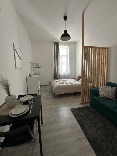 a living room with a couch and a bed at Dolce Vita Budapest in Budapest