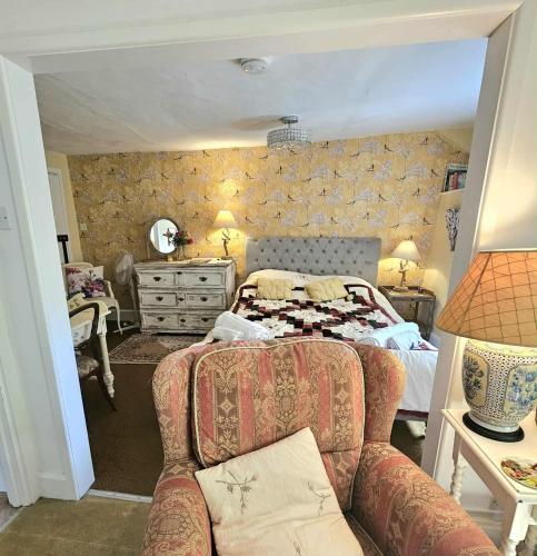 a bedroom with a bed and a couch at West Wing Lurley Manor in Washfield