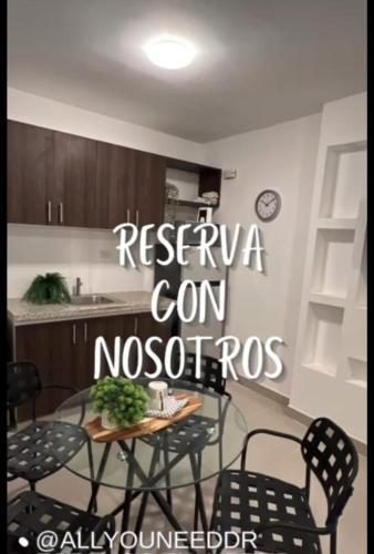 a kitchen with a table and chairs in a room at New apartment near the airport AILA 