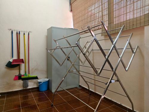 a metal sculpture in a room with baseball bats at Peach Homestay Tasik Puteri in Rawang