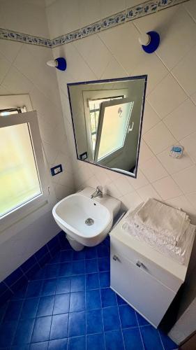 a bathroom with a sink and a toilet and a mirror at Resort Dependance di Villa Rosa Maria in Savona