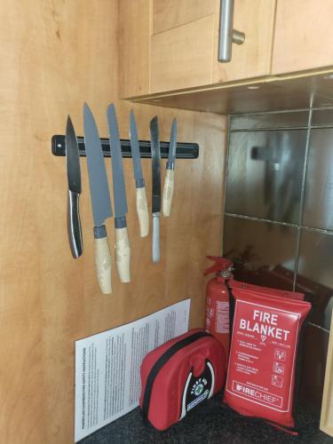 a group of knives hanging on a kitchen wall at Lovely 2 bed flat in the VERY CENTRE of Newcastle in Newcastle upon Tyne