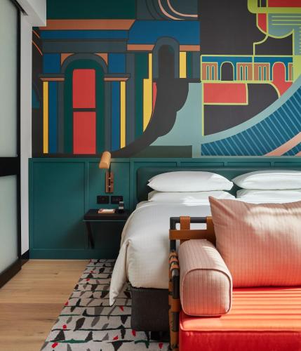 a bedroom with a bed and a colorful wall at Caption By Hyatt Central Sydney in Sydney