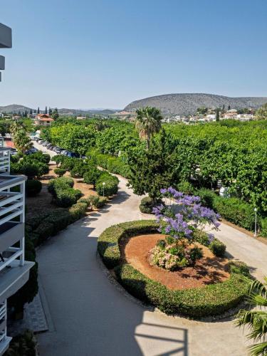 a view of a garden with purple flowers at The Grove Seaside Hotel in Dhrepanon