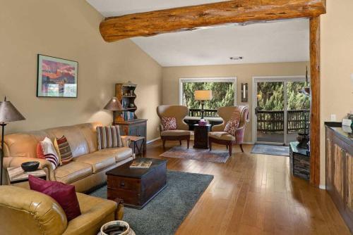a living room with a couch and a table at Spacious Sedona Splendor with Community Spa & Pool in Sedona