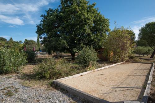 a path in a park with a tree at Gîte Chêne ou Murier in Les Vans
