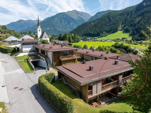 an aerial view of a building with a church at Schöneben Haus Wenters in Wald im Pinzgau