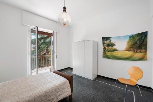 a bedroom with a bed and a large window at Outlet2000 in Serravalle Scrivia