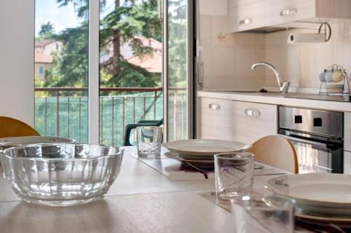 a kitchen with a table with plates and bowls on it at Outlet2000 in Serravalle Scrivia