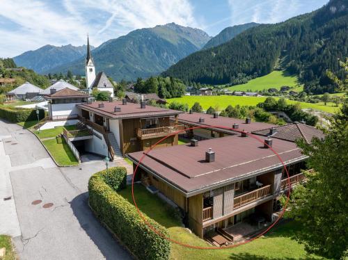an aerial view of a building with a church at Schöneben Haus Edelweiss in Wald im Pinzgau