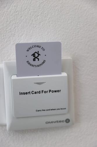 three boxes sitting on top of an insert card for power at Xhani's Rooms Durres in Durrës