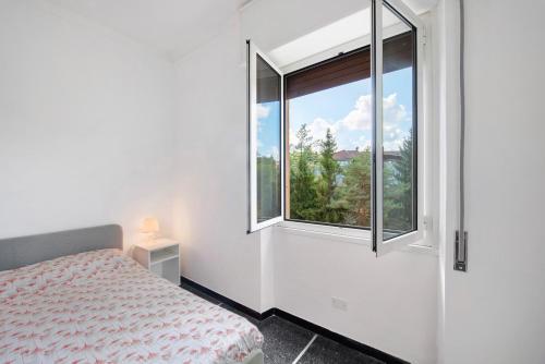 a bedroom with a bed and a large window at Outlet2000 in Serravalle Scrivia