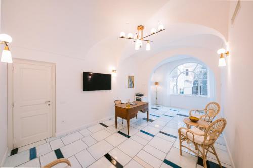 a living room with a table and chairs at Residenza Dea Amalfi in Amalfi