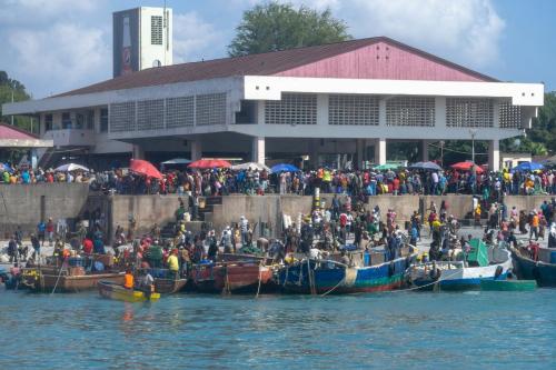 a group of people in boats in front of a building at Holiday Inn Dar Es Salaam by IHG in Dar es Salaam