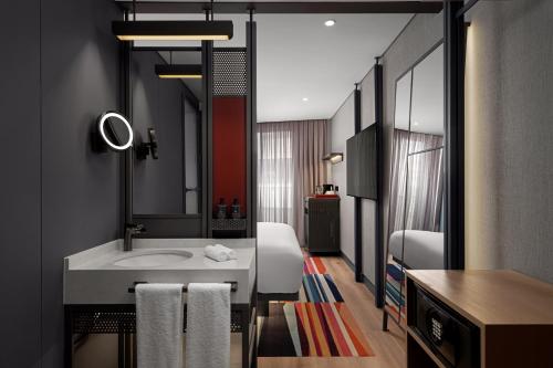 a bathroom with a sink and a mirror at Aloft by Marriott Istanbul Karakoy in Istanbul