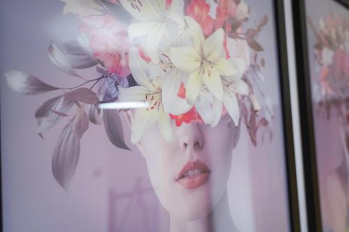 a woman with flowers on her head in a picture at 3-Bed House, Sleeps 5,Bedford in Marston Moretaine