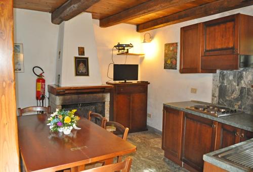 a kitchen with a table with flowers on it at Borgo Isola Santa in Isola Santa