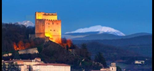 a castle on a hill with a mountain in the background at Chalet 1 in Aouste-sur-Sye