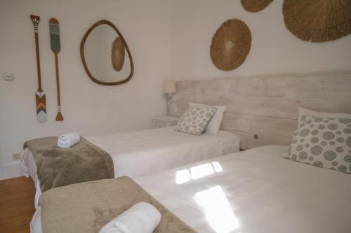 a living room with two beds and a couch at Porto Surf Lodge in Porto