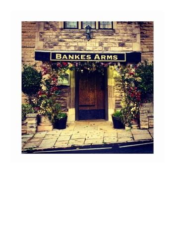 a entrance to a building with a sign that reads bananas amps at Bankes Arms Hotel in Wareham