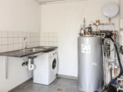 a kitchen with a washing machine and a sink at Holiday Home Odeta - 25km from the sea by Interhome in Højer