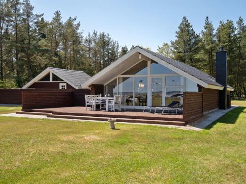 a home with a large deck and a house at Holiday Home Saila - 500m to the fjord by Interhome in Blåvand