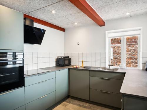a kitchen with a sink and a stove at Holiday Home Odeta - 25km from the sea by Interhome in Højer