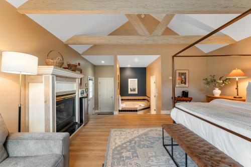 a large bedroom with a fireplace and a bed at Red Clover Inn in Mendon