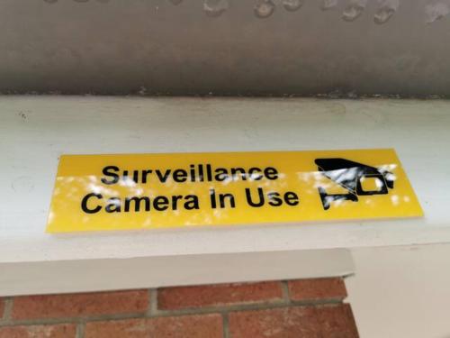 a yellow sign sitting on a white bench at 1 bedroom guesthouse close 2Train&Westfield in Hornsby