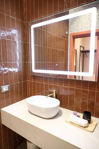 a bathroom with a sink and a mirror at Xhani's Rooms Durres in Durrës