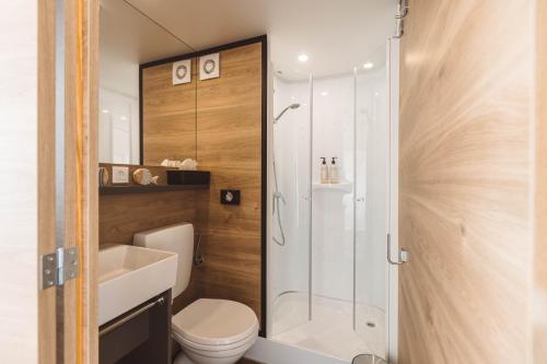 a bathroom with a shower and a toilet and a sink at Glamping Resort Olive and Sea in Bibinje