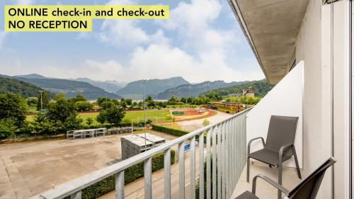an apartment balcony with a view of a playground at Anstatthotel Horw - app self-check-in in Luzern